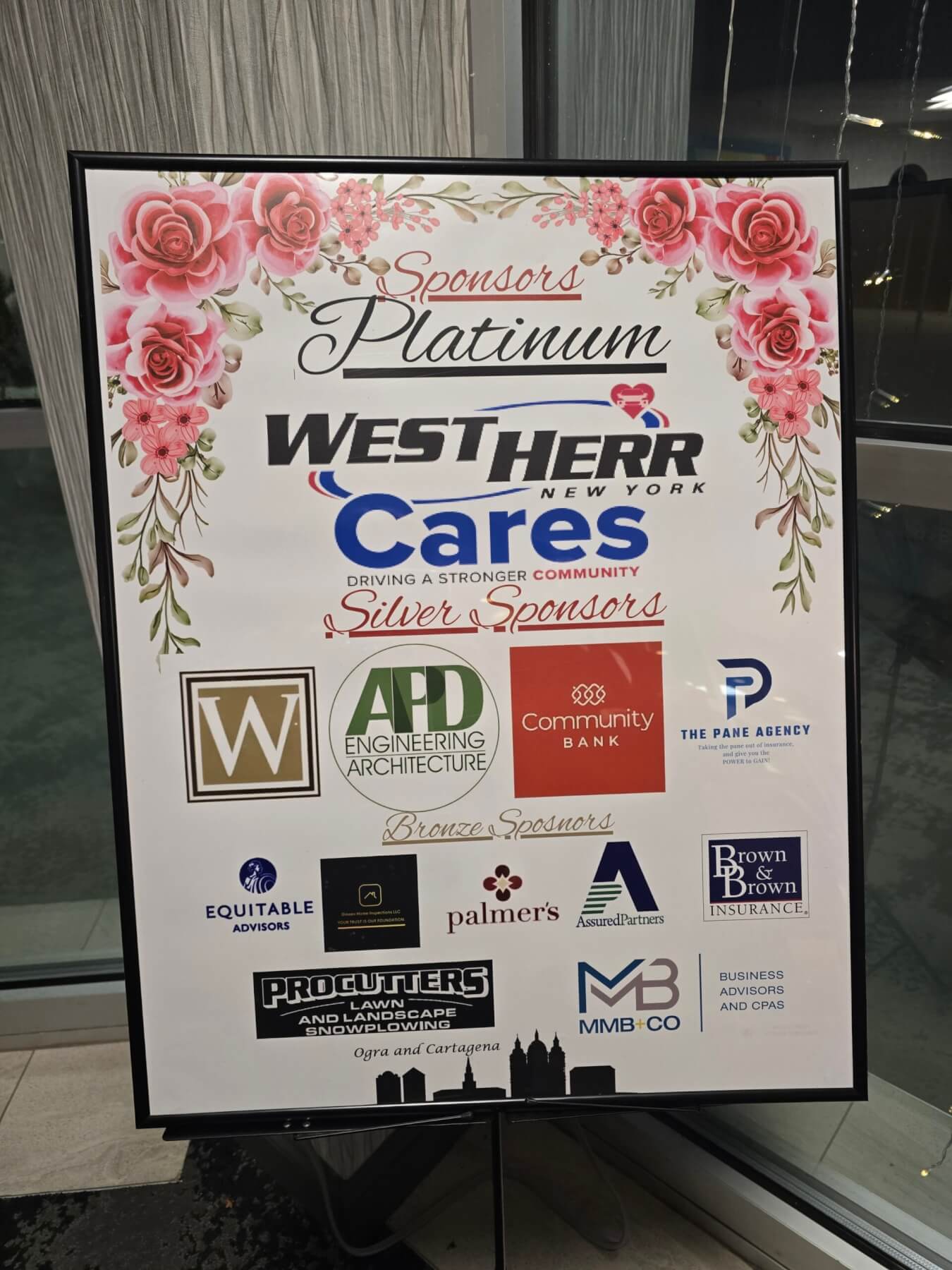 Sponsor board featuring Westherr and others at a community event, highlighting local business support and engagement.