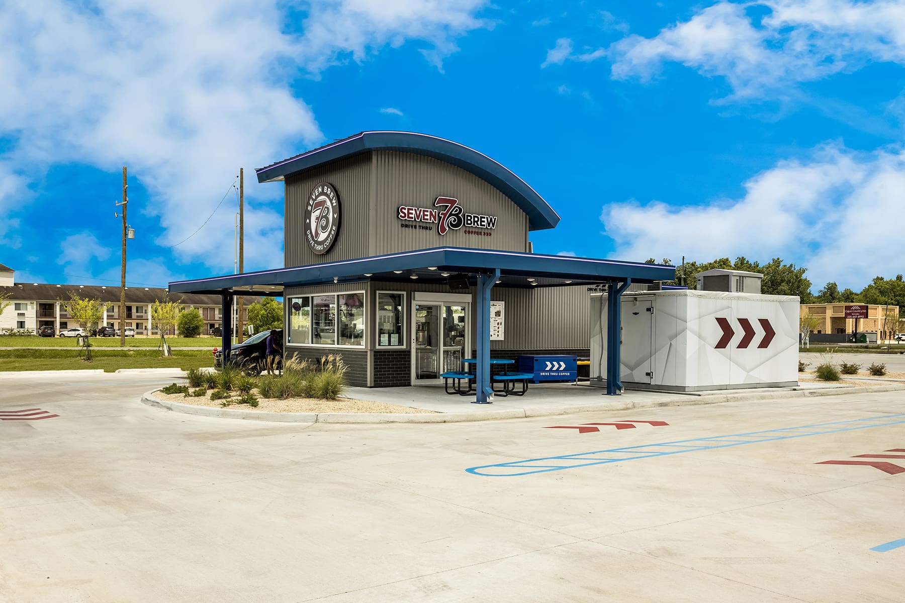 Seven Brew Coffee drive-thru location with blue sky backdrop.