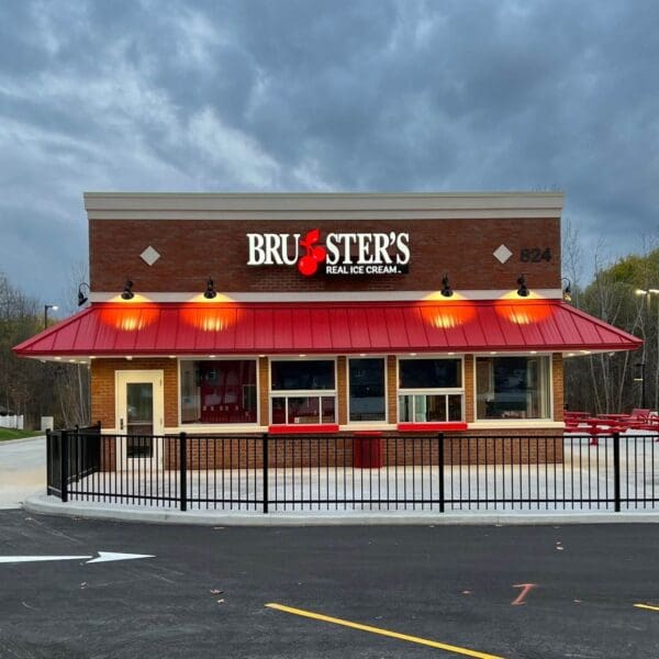 Exterior of Bruster's Ice Cream shop with red awning and sign.