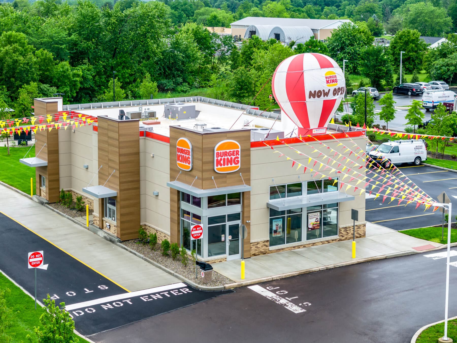 Burger King grand opening with festive balloon and banners. Fresh fast food now available.