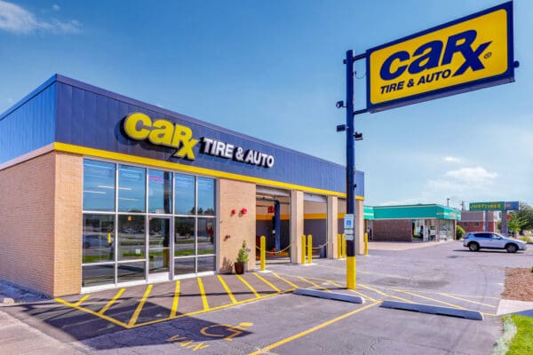 CarX Tire & Auto store exterior showcasing entrance and signage on a sunny day.