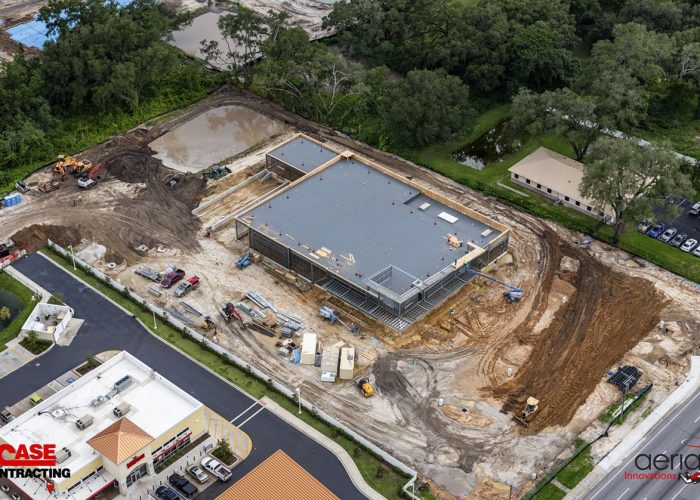 Aerial view of a commercial construction site by CASE Contracting, showcasing ongoing building progress.