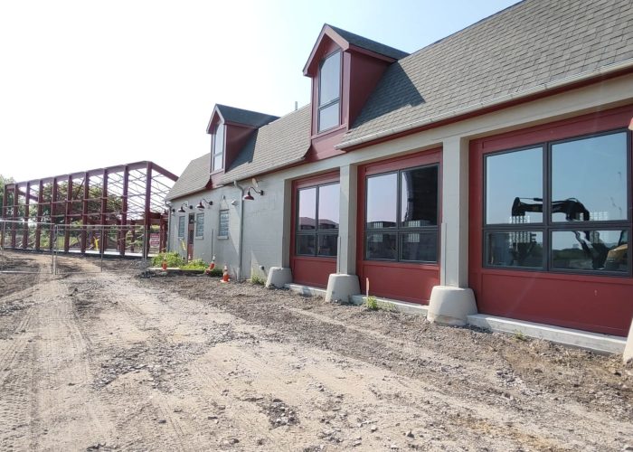 New building construction at industrial site showing progress and modern design.