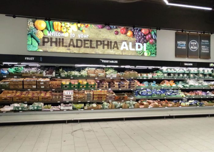 Aldi Philadelphia store produce section with fruits, vegetables, and salads on display.
