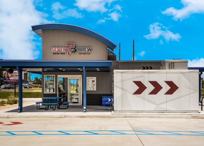 Seven Brew Coffee drive-thru location against a bright blue sky.