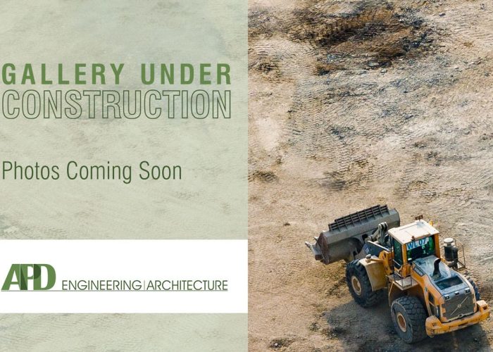 Gallery under construction announcement with bulldozer at APD Engineering site, photos coming soon.