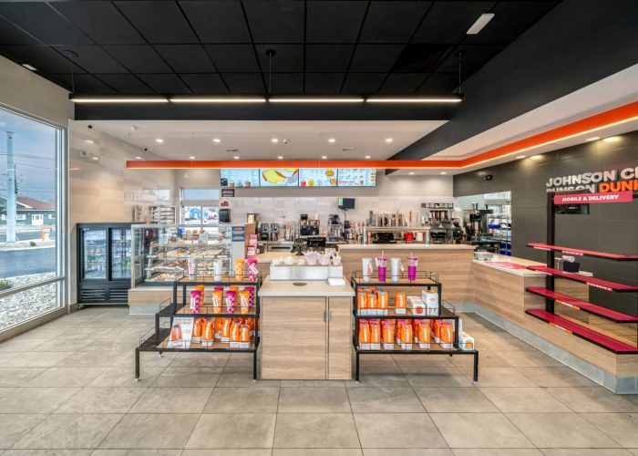 Bright and modern Dunkin' store interior featuring a coffee and bakery display.