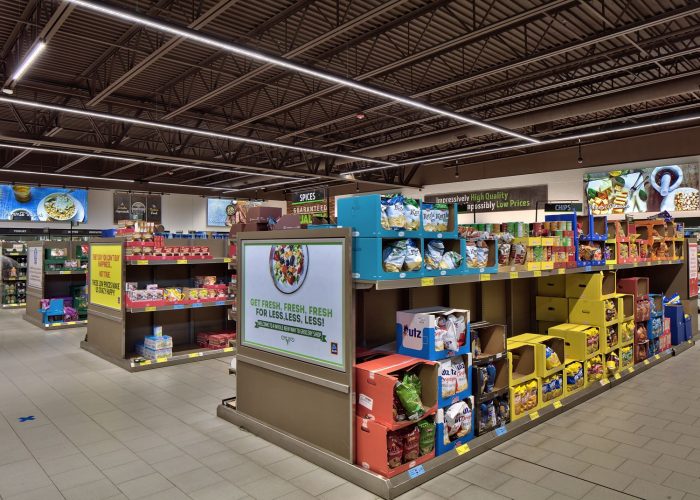 Grocery store snack aisle featuring a variety of chip brands with vibrant packaging.