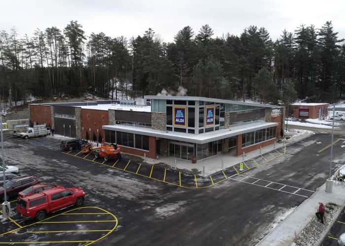 Aldi grocery store with a snowy landscape, showcasing spacious parking.