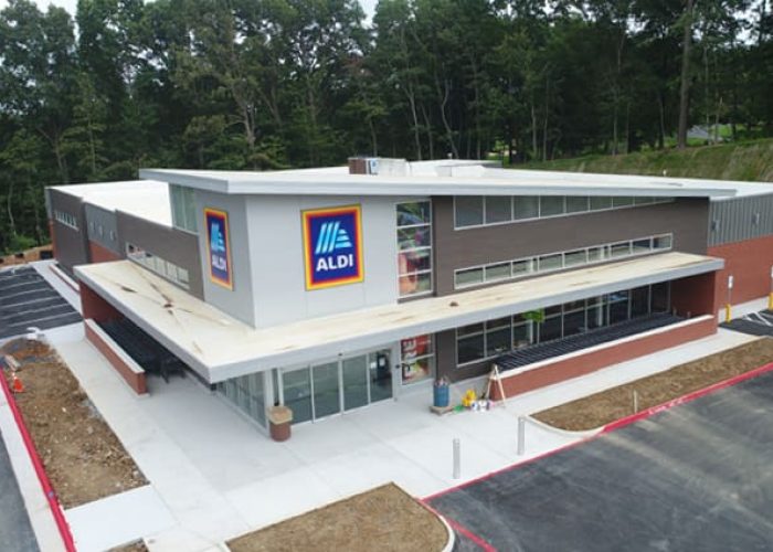 Aldi store exterior with parking lot, featuring modern design.