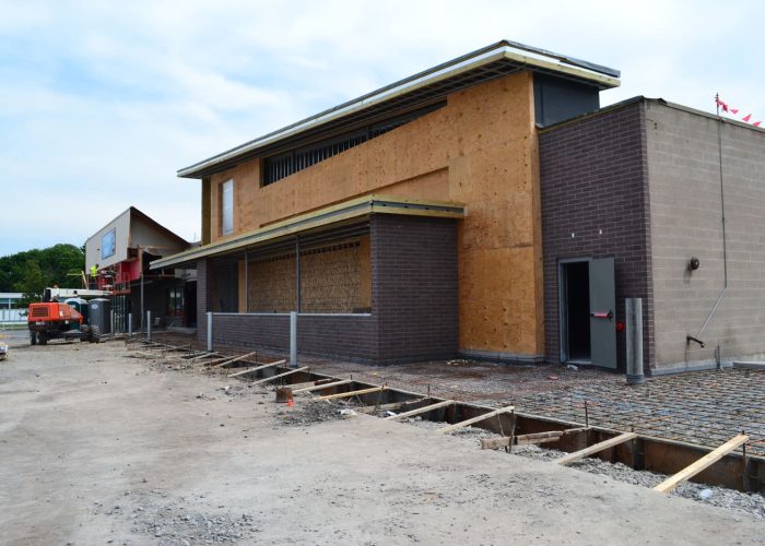 Construction site of a modern commercial building under development, showcasing structural progress and materials.