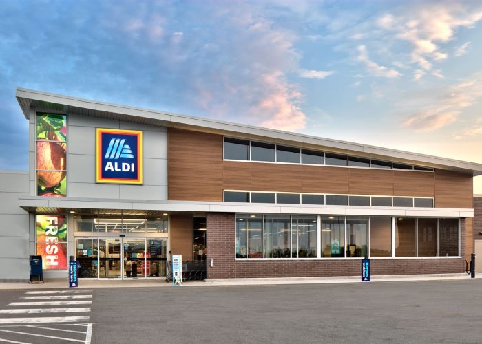 Aldi grocery store exterior under a vibrant sky, showcasing modern design.