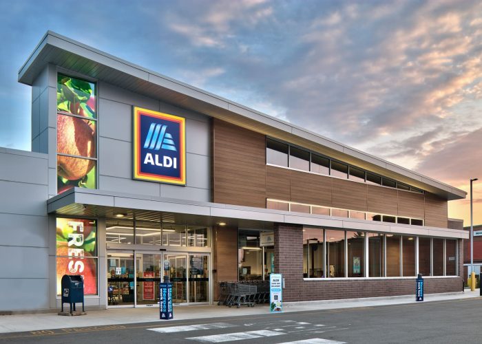 Exterior view of an Aldi supermarket at sunset, showcasing the modern store design.