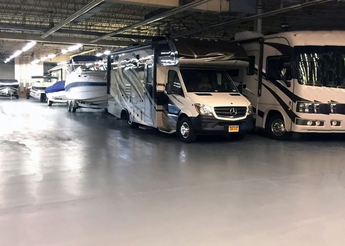 Indoor storage facility housing RVs and boats, maintaining pristine condition for secure long-term storage.