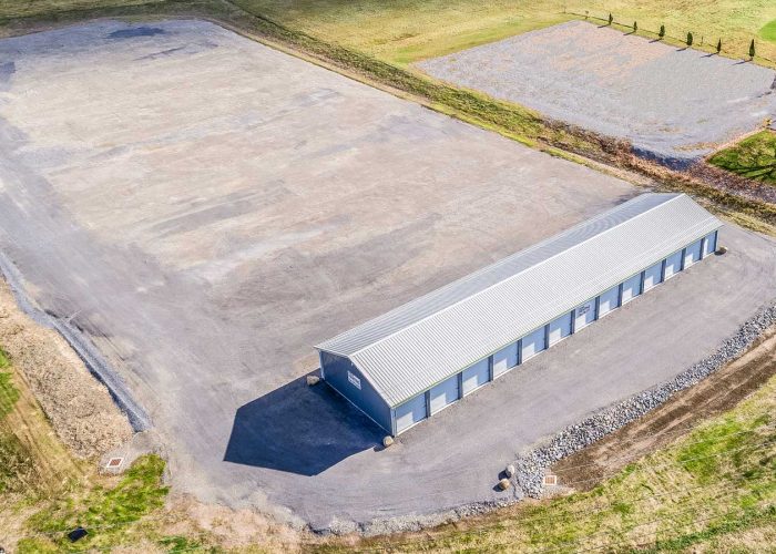 Aerial view of storage building and empty lot at Horizon Farms, ideal for expansion or development.