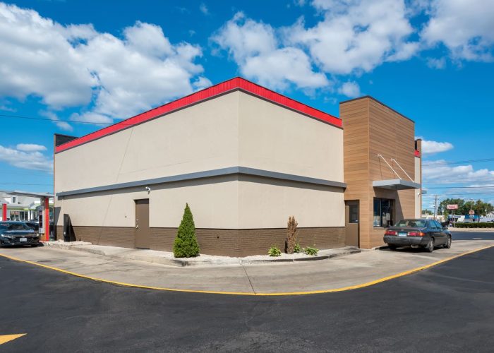 Drive-thru view of a fast-food restaurant with cars, emphasizing convenience and quick service.