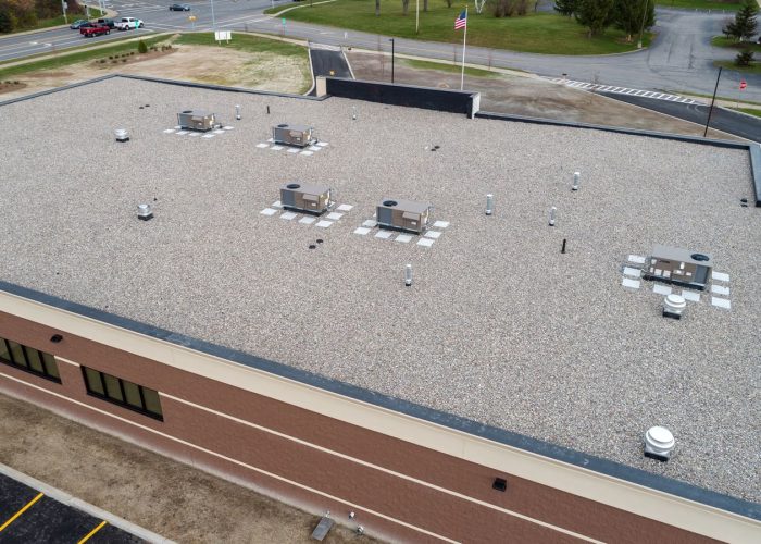 A flat commercial roof with HVAC units, showcasing efficient design for urban buildings.