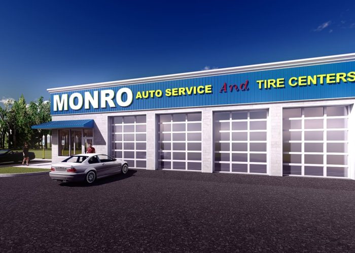 Monro Auto Service storefront, featuring tire centers and customer vehicles in parking lot on a clear day.
