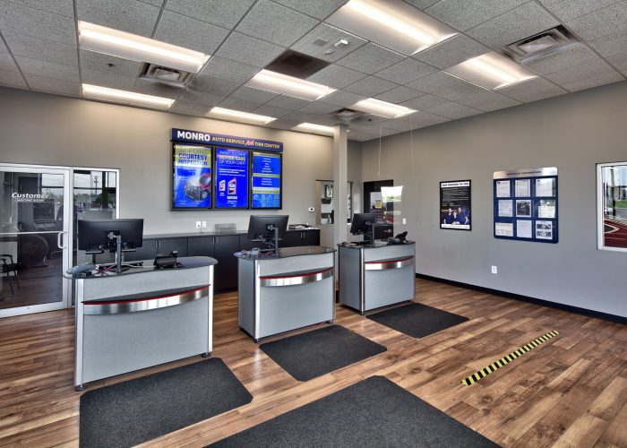 Modern Monro Auto Service customer area with computers and signage, showcasing professional auto care services.
