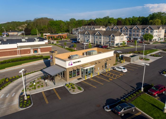 Taco Bell restaurant exterior in a suburban setting with parking area.