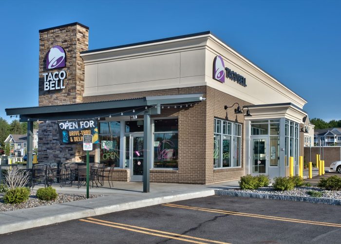 Taco Bell storefront with drive-thru open sign, inviting customers for quick service meals.