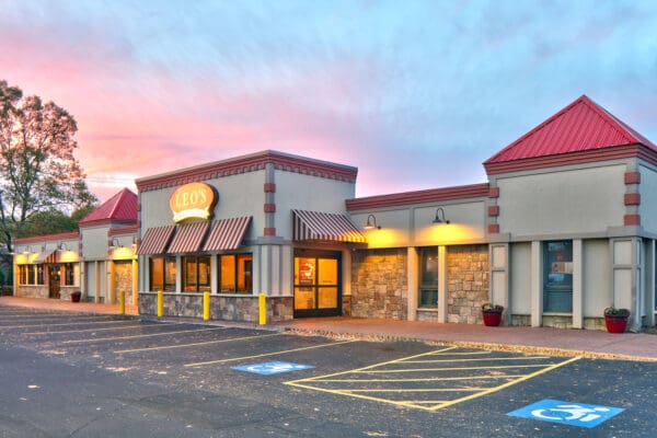 Leo's Diner exterior at sunset with accessible parking. Perfect for family dining and comfort food cravings.