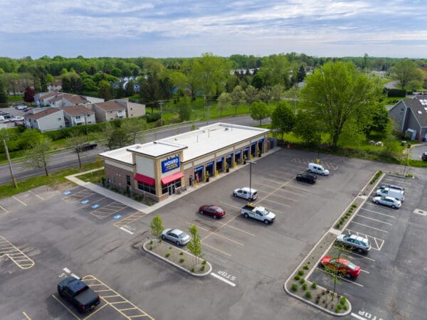 Monro Auto Service and Tire Center in a suburban location with parking and greenery.