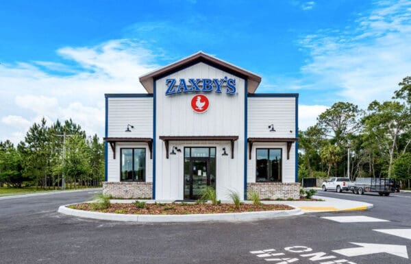 Exterior view of Zaxby's restaurant in a landscaped setting, highlighting the brand's inviting presence.